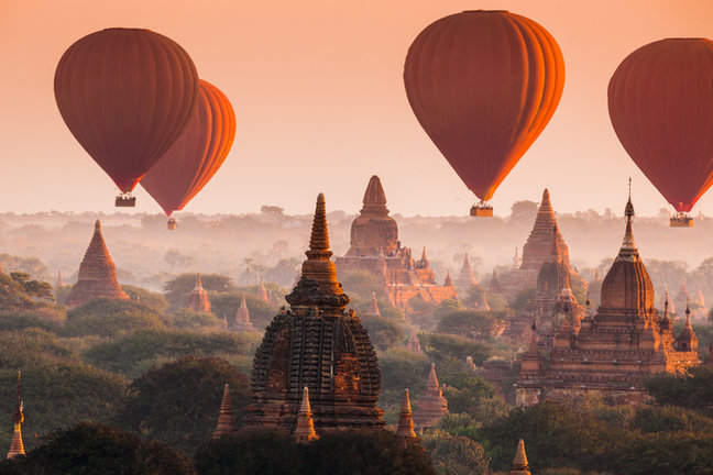 Hot air balloons rise over Bagan alongside the morning sun