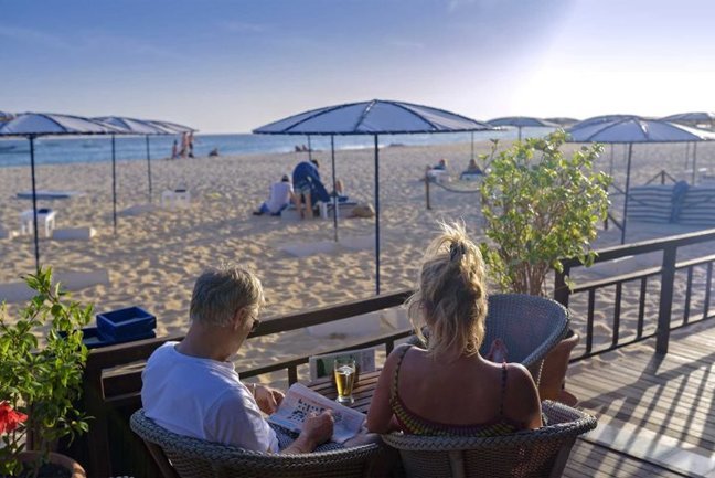 Watch the sunset while enjoying a cocktail at the beach bar