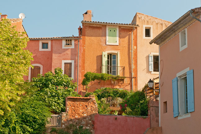 Roussillon 's buildings are painted with the colourful ochre sands of it's quarry