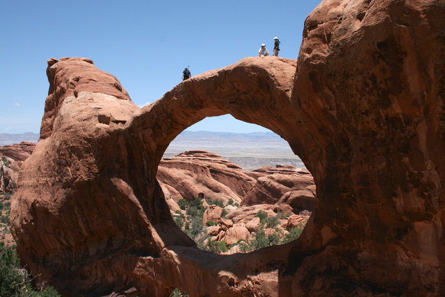 Walking the Double O Arch in Arches National Park