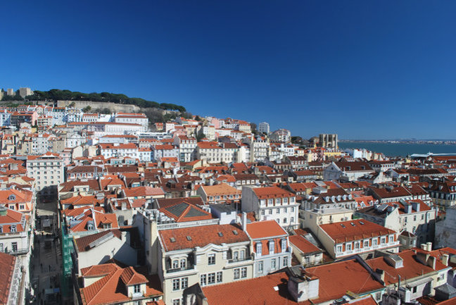 Looking across the city's red roofs to the hilltop Castello de Sao Jorge in Lisbon's historic Alfama district
